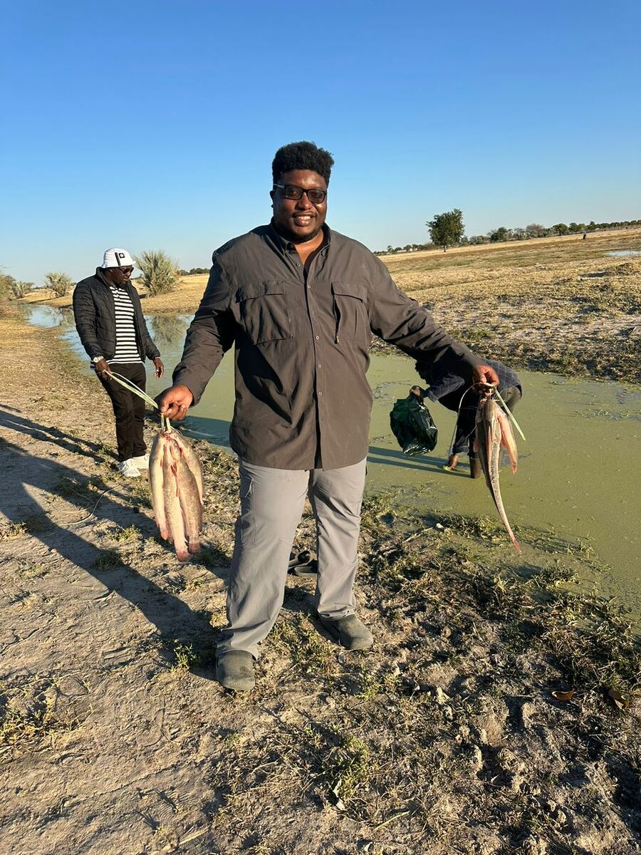 Hiskia Asino with the day's catch at a Tru Africa pond